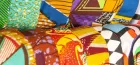 Close-up on rolls of very colourful fabric, in all different prints.
